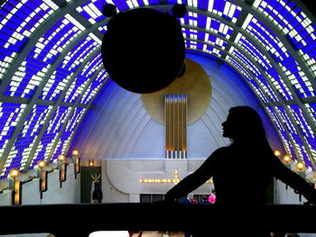 Silhouette people in illuminated room