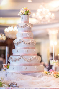 Wedding cake and wedding candlestick with flower decoration the joy symbol of the bride.