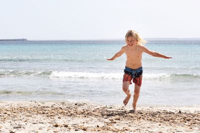Full length of woman standing at beach