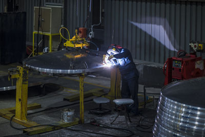 Worker welding in factory