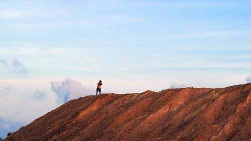 Man standing on desert against sky