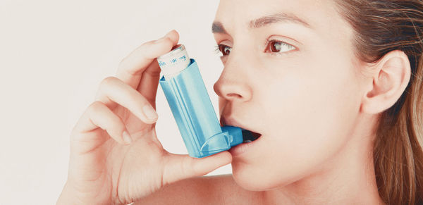 Close-up portrait of a woman drinking water