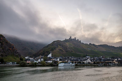 Panoramic view of buildings and mountains against sky