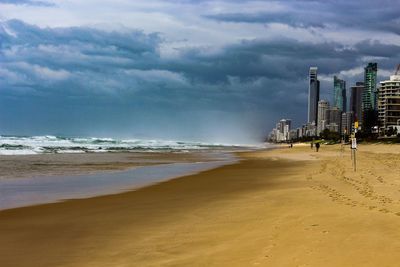 Scenic view of beach and buildings against sky