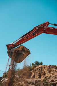 Low angle view of old construction site against clear blue sky