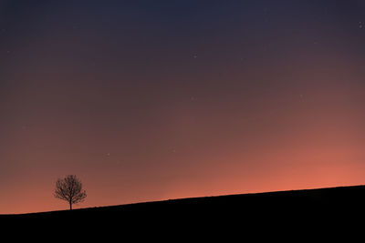 Scenic view of silhouette landscape against sky at night