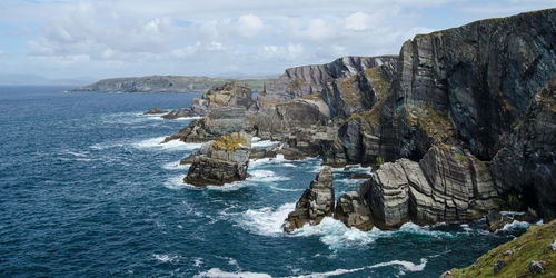 Rock formations in sea against sky