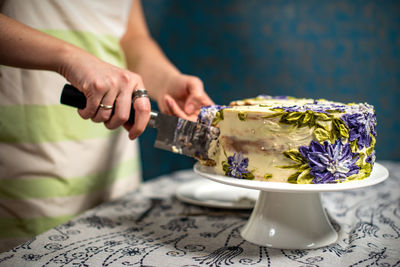 Hand holding tea cup on table