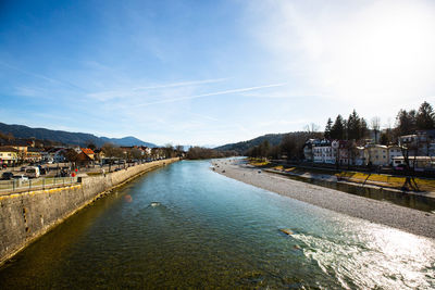 River amidst city against sky