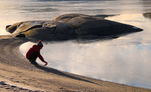 Side view of man surfing on beach