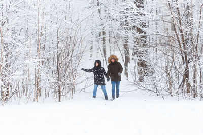 People standing on snow covered land