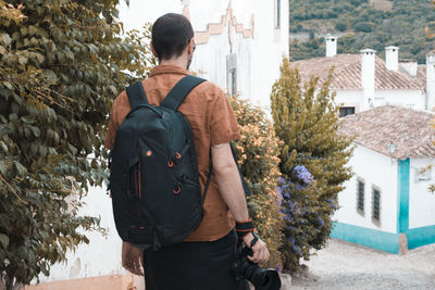 Rear view of man standing by building