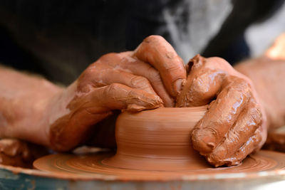 Hands of a potter. potter making ceramic pot on the pottery wheel