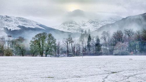 Scenic view of snow covered mountains against sky