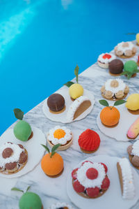Desserts in an outdoors birthday party. sweets by the pool.