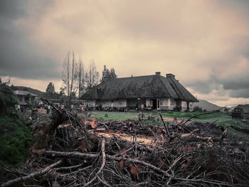 Abandoned house on field against sky