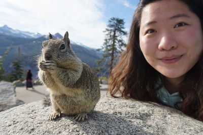 Portrait of woman posing with squirrel