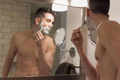 Shirtless man in bathroom