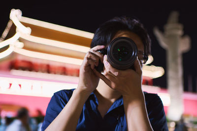 Young woman photographing through camera