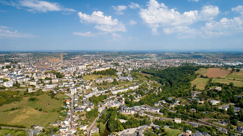 High angle view of townscape by sea against sky