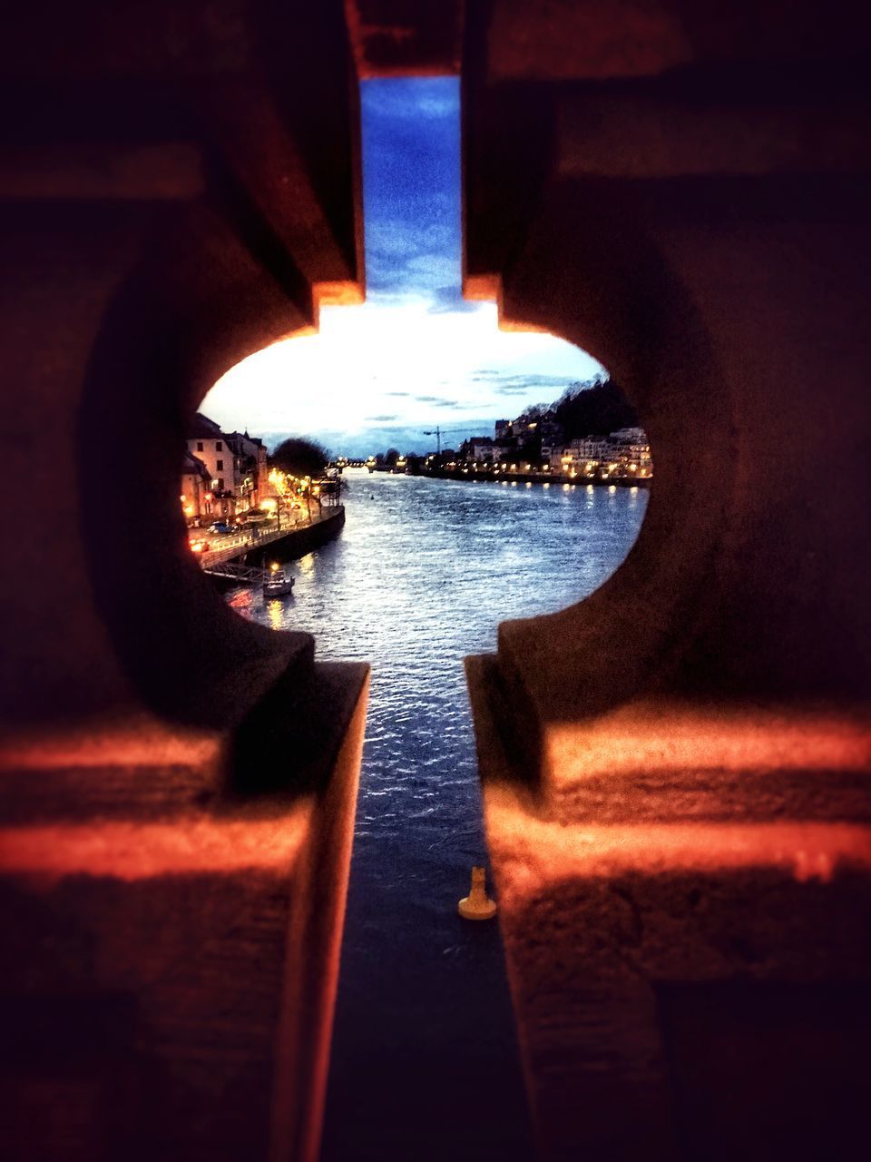 VIEW OF ILLUMINATED BRIDGE OVER SEA