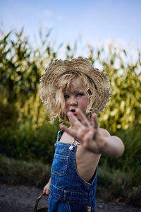 Portrait of cute girl standing against plants