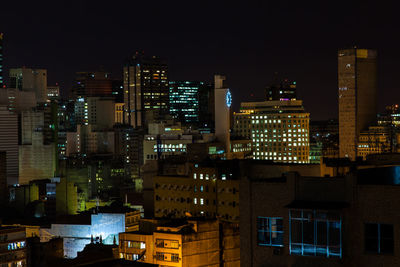 Illuminated buildings in city at night