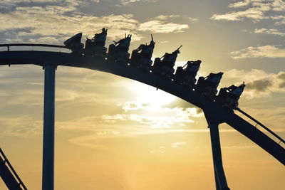 Low angle view of bridge against cloudy sky