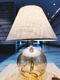 Close-up of illuminated lamp on table