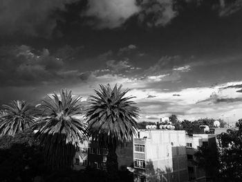 Buildings against cloudy sky