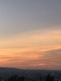 Scenic view of city against sky during sunset