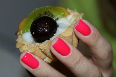 Cropped hand of woman holding dessert