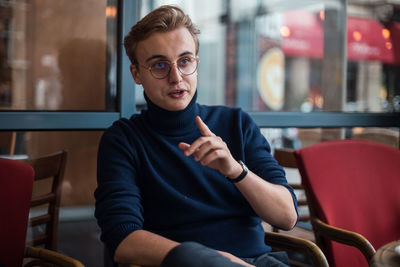 Portrait of young man sitting in cafe