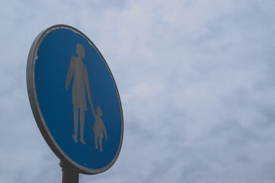 Low angle view of road sign against sky