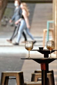 Side view of woman wine glass on table