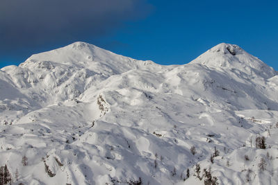 Scenic view of snowcapped mountains against clear blue sky