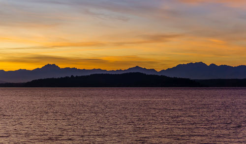 A silhouette shot of a sunset over the olympic mountains in washington state.