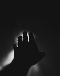 Silhouette person shadow on hand