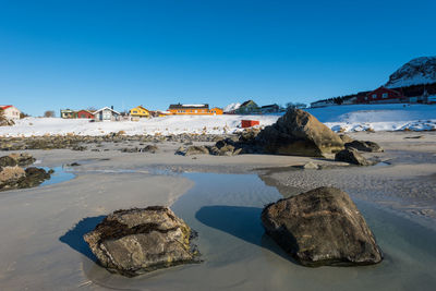 Panoramic view of beach against clear blue sky