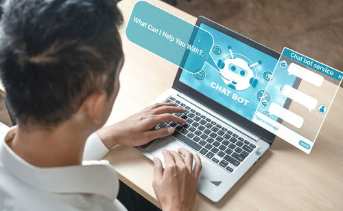 High angle view of man using laptop on table