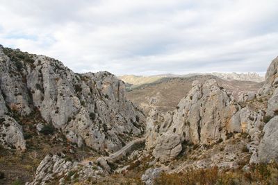 View of rock formations against cloudy sky