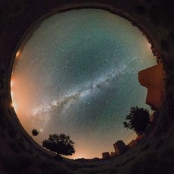 Low angle view of silhouette trees against sky at night