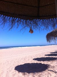 Scenic view of beach against blue sky