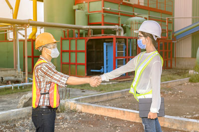 Side view of man working at construction site