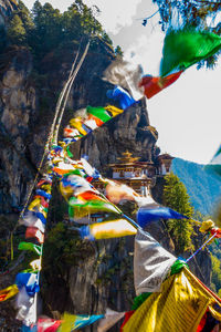 Low angle view of multi colored statue against trees