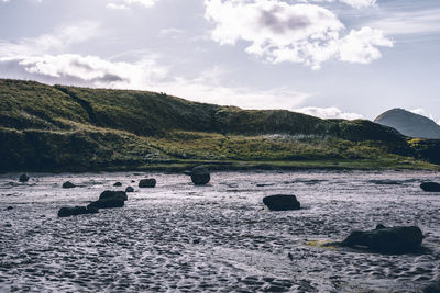 Scenic view of sea and rocks against sky