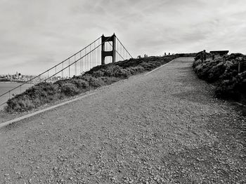 View of suspension bridge against cloudy sky