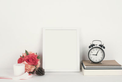 Close-up of flower vase on table against white background