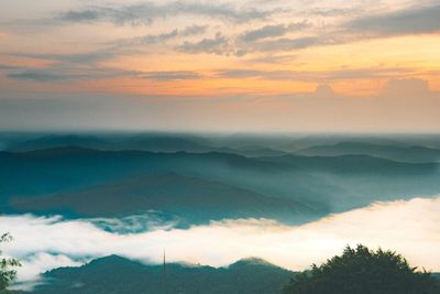 Scenic view of silhouette mountains against sky at sunset