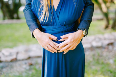 Midsection of woman standing on field